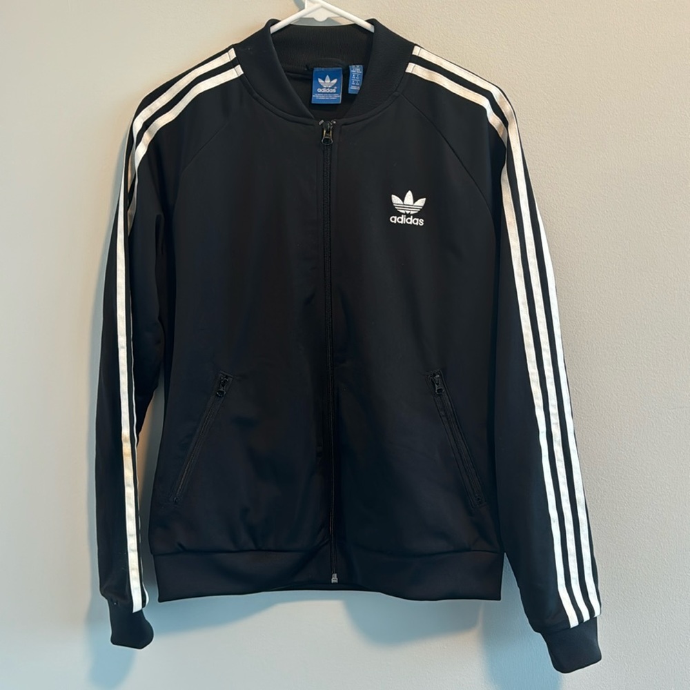 Retro Adidas zip up three stripe jacket with logo on the back. (size M)